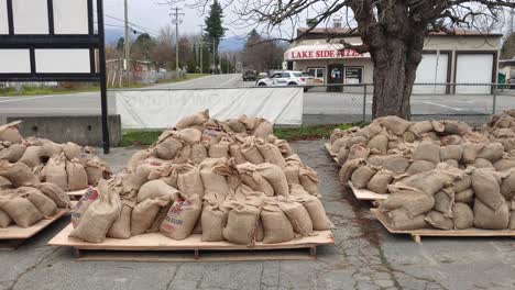 prepared sandbags on pallets on a parking lot for historical and disastrous floods in the province of british columbia in canada