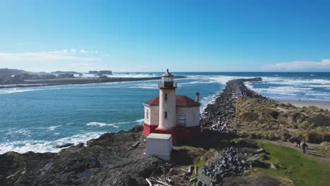 stunning 4k aerial drone shot showcasing coquille river lighthouse with pedestrians walking overlooking the pacific ocean