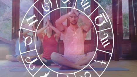 Animation-of-horoscope-zodiac-wheel-over-diverse-people-practicing-yoga