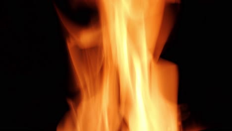 close-up fire flames on the dark. beautiful bright orange coloured. large and moving aggresively.