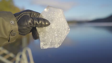 person dropping a piece of ice in slow motion