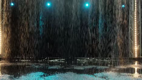 el efecto de la lluvia en el estudio acuático contra el fondo de los reflectores. textura del agua. cámara lenta