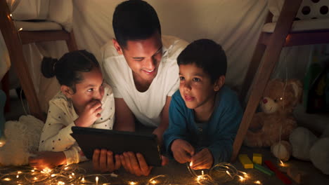 night, father and children with a tablet