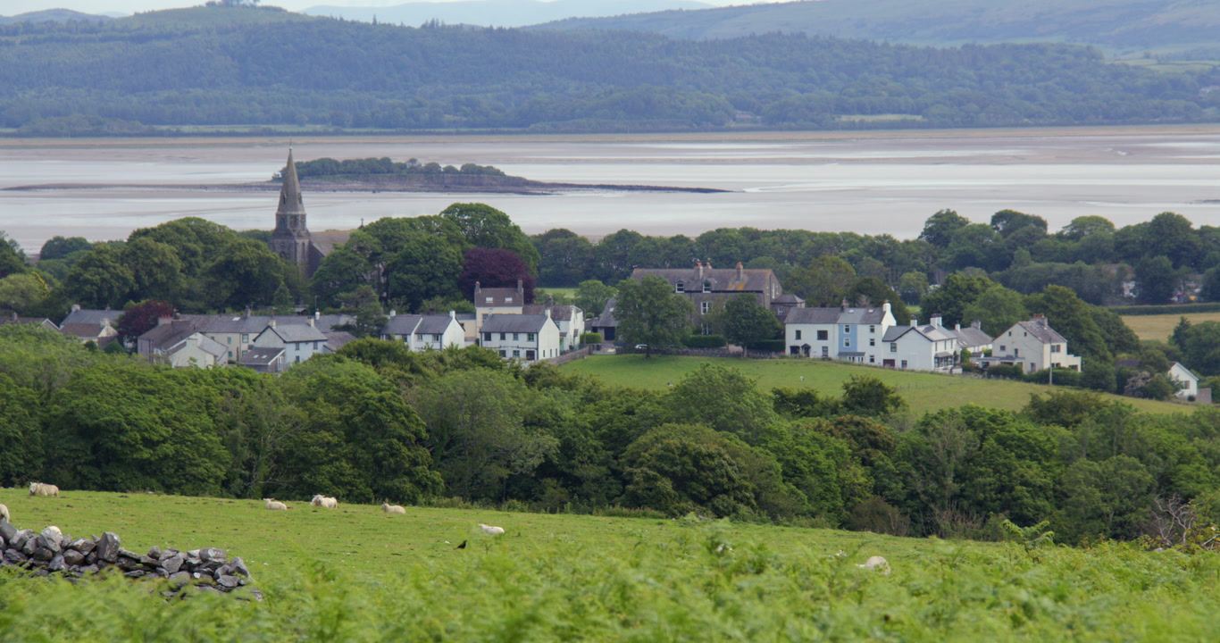 Long shot of Village Bardsea with Chapel Island and Morecambe Bay in background near Ulverston at Circle, Birkrigg Stone Circle,