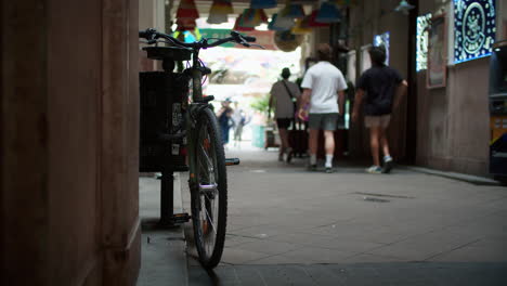 bicycle parked in a city alleyway