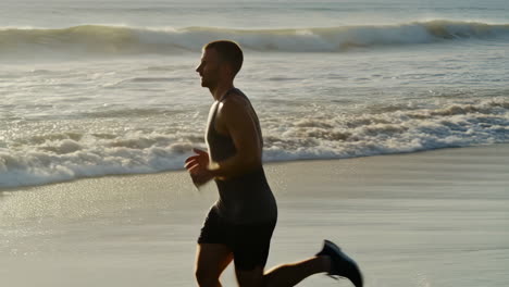 man jogging on beach by the ocean