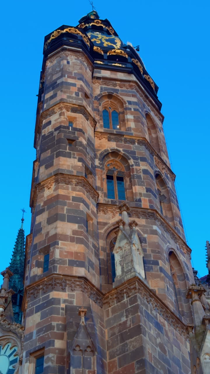 Clock tower of the ancient Cathedral of St. Elisabeth in Kosice, Slovakia. Low angle view at the beautiful dome at the backdrop of blue sky at sunset.