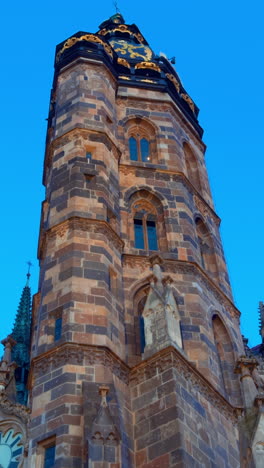 Clock tower of the ancient Cathedral of St. Elisabeth in Kosice, Slovakia. Low angle view at the beautiful dome at the backdrop of blue sky at sunset.