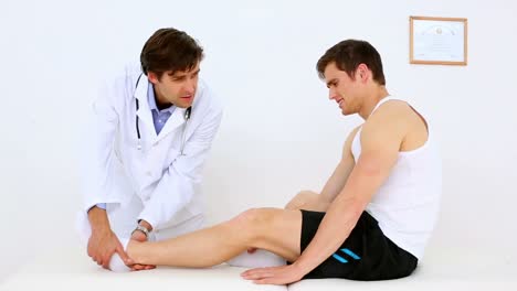 doctor moving patients injured ankle