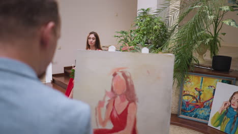 artist draws young woman figure in gallery. skilled painter creates portrait of attractive model in art studio. creative man works with live model