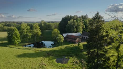 Casas-Rústicas-De-Granero-Con-Un-Entorno-Natural-Verde-Cerca-Del-Estanque-En-Warmia,-Polonia