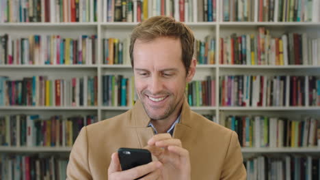 portrait of attractive caucasian businessman texting browsing online research using smartphone technology in library bookshelf background