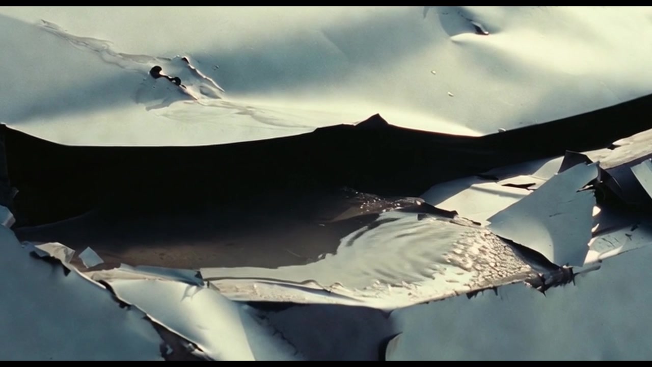 Water Pooling on Damaged Metal Surface