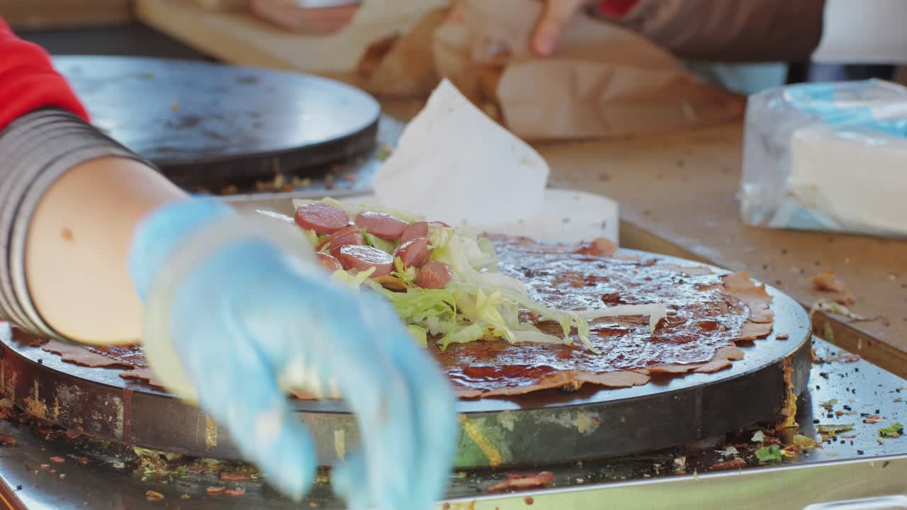 Chinese traditional street food Jianbing close-up. Cooking asian crepe Jianbing, one of China most popular street breakfasts. High quality 4k footage