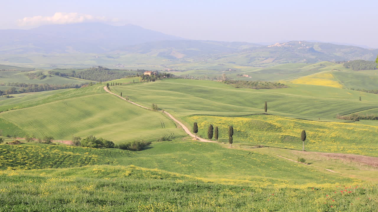 A lone farmhouse in the Val d'Orcia in Tuscany, Italy. Designated as a World Heritage by UNESCO, the Val d'Orcia is a landscape of distinctive aesthetics and flat chalk plains