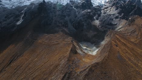 aerial view of salkantay mountain base and dried up glacier pond in the andes, peru