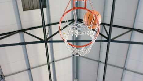 scoring point, basketball going through hoop in indoor gym, copy space