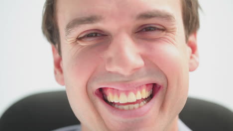 Businessman-laughing-while-sitting-on-a-swivel-chair