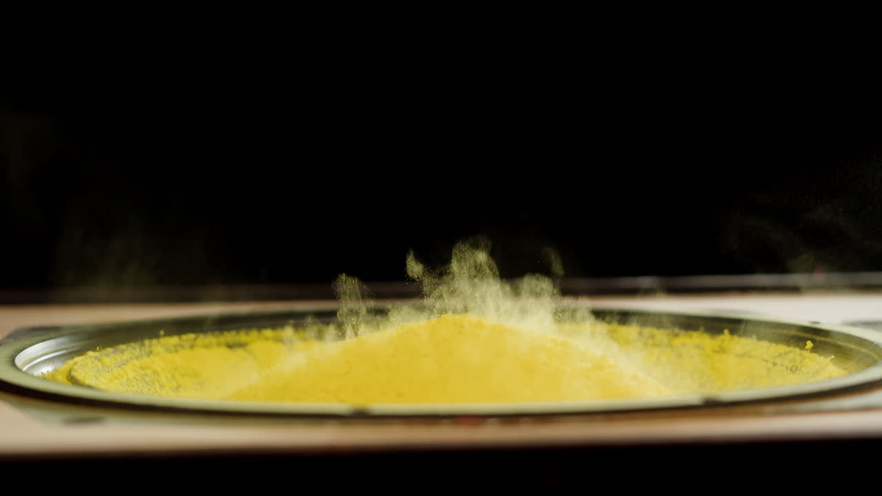 Yellow Powder Dancing on Speaker Cone from Bass Vibration