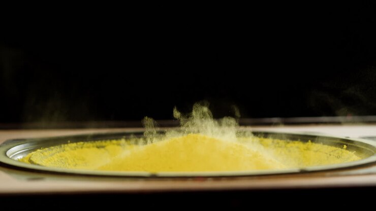 Yellow Powder Dancing on Speaker Cone from Bass Vibration