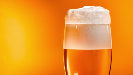 Lager-beer-settles-in-the-glass-with-a-white-cap-of-foam