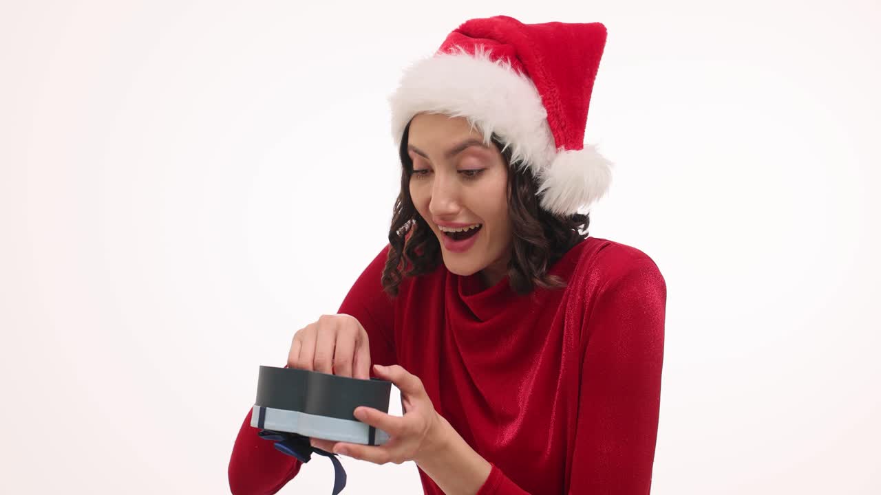 Woman in Santa Hat Excitedly Opens Gift to Reveal Car Keys