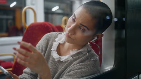 woman using smartphone on a train