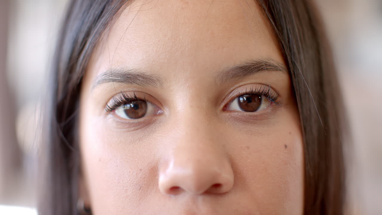 Biracial young woman with brown eyes looking forward at home