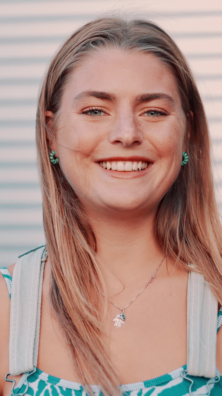 Close-up Portrait of a Happy Young Woman Smiling Outdoors