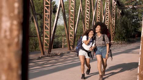 black friends embracing on old bridge