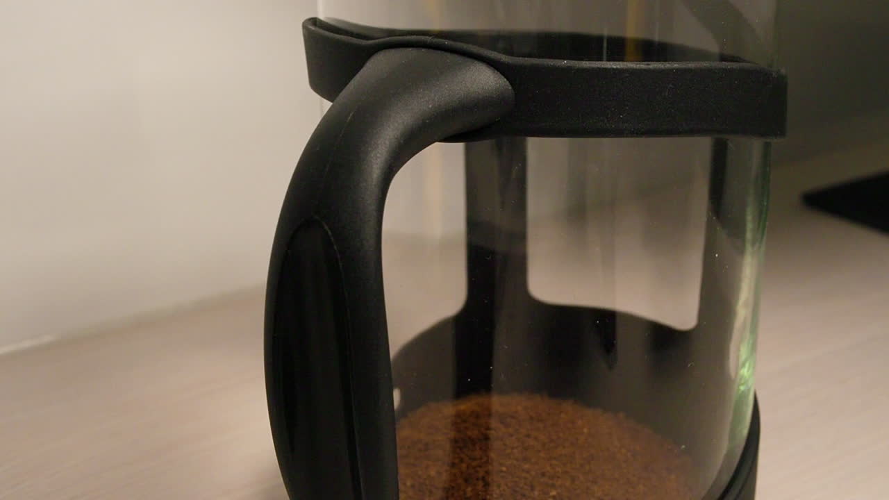 primer plano de hacer café instantáneo agregando gránulos y agua caliente