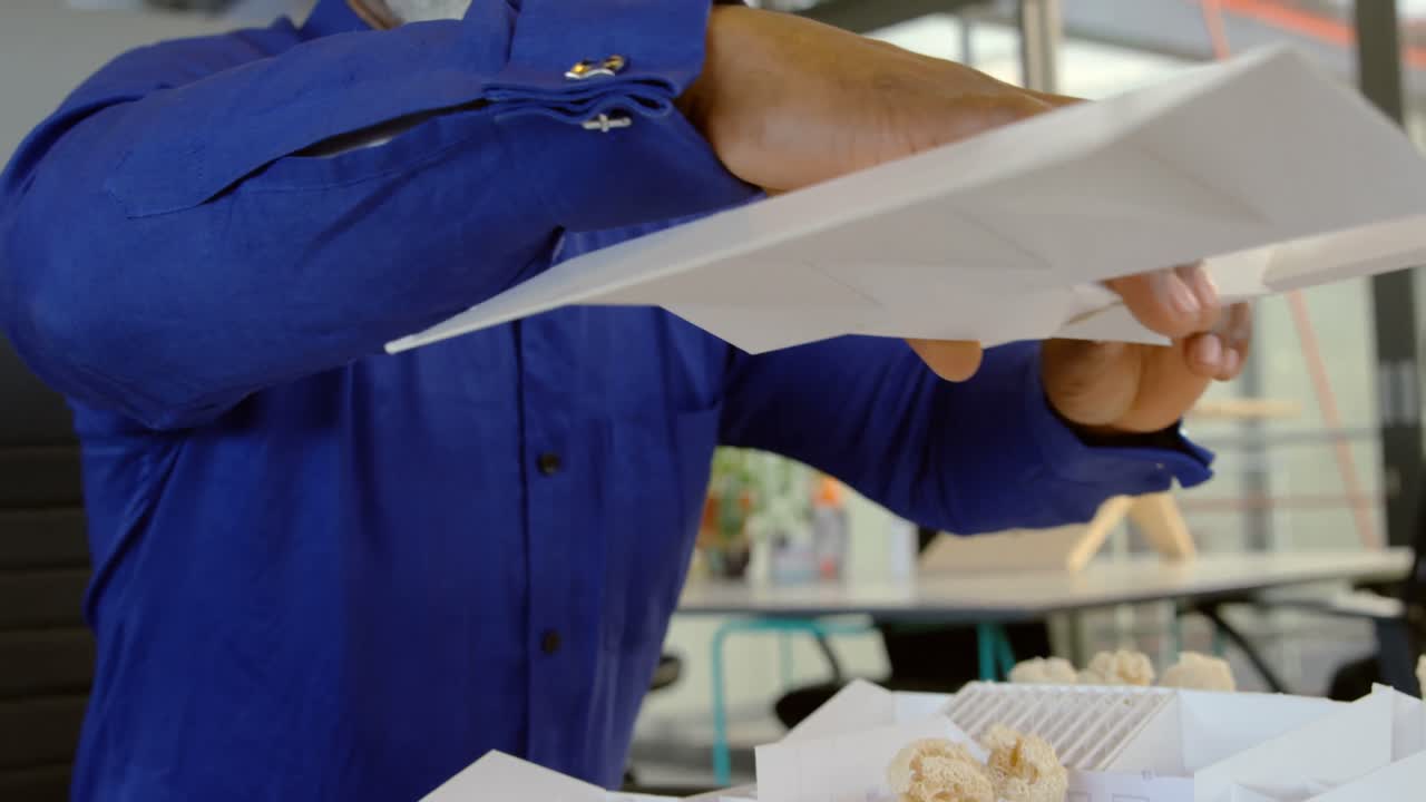 Executive working on architectural model 4k