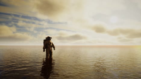 Spaceman-in-the-sea-under-clouds-at-sunset