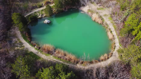 aerial view of a turquoise lake in a forest