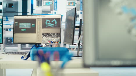 simulation software on computer monitor in empty solar panels plant