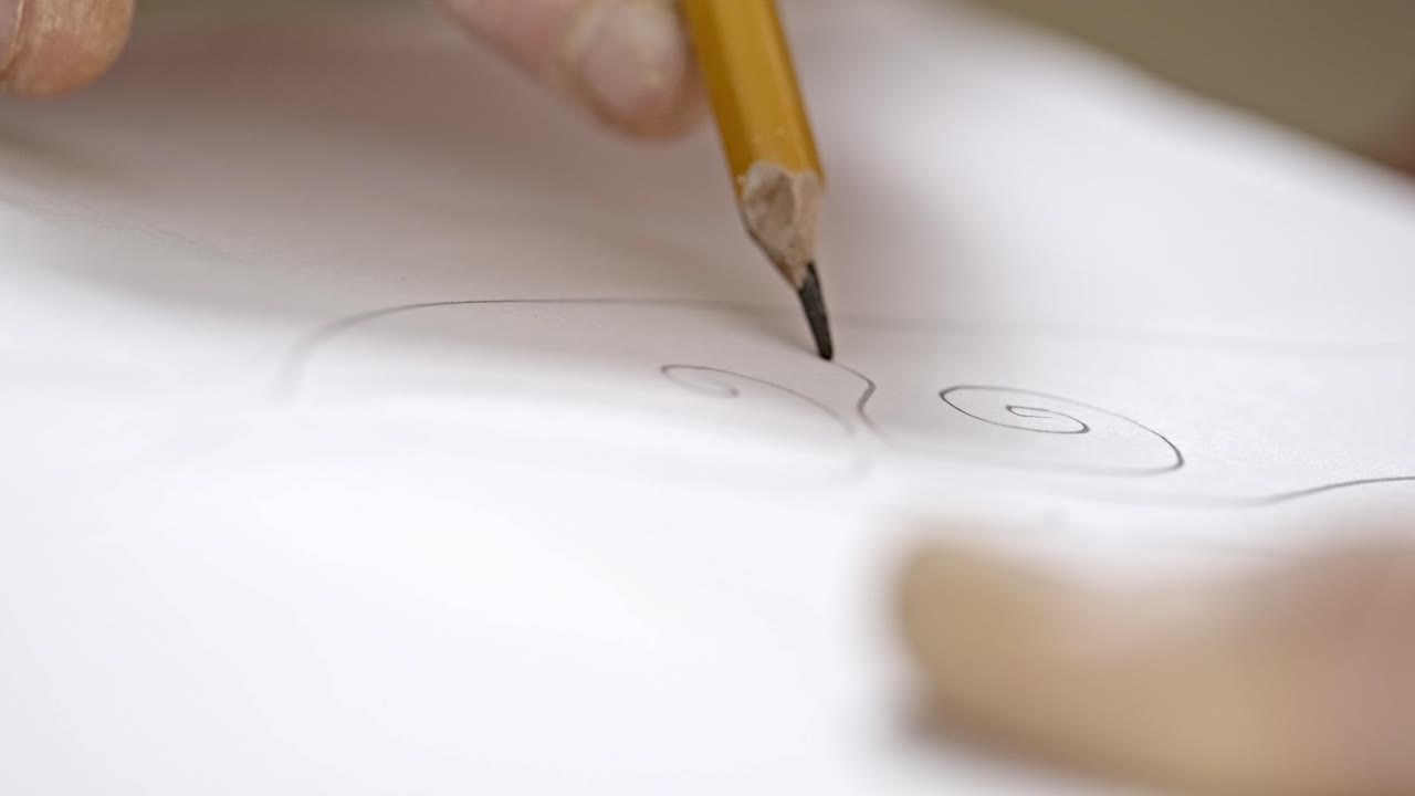 Close-up of hand drawing with a pencil