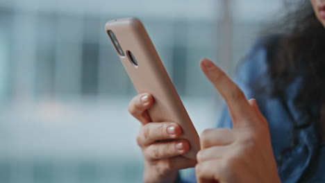 closeup hand touching cellphone screen. relaxed woman browsing mobile internet