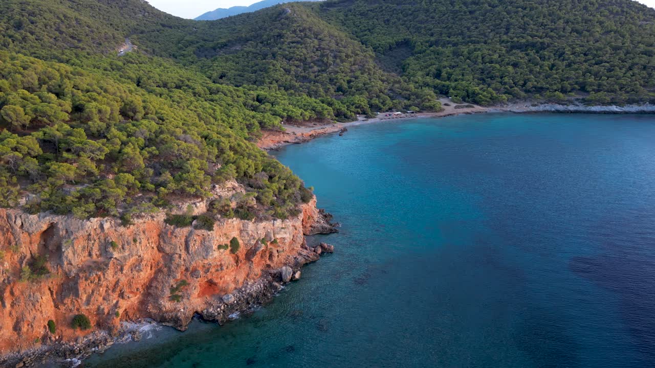 Stunning aerial view over secluded beach on Greek island at sunset