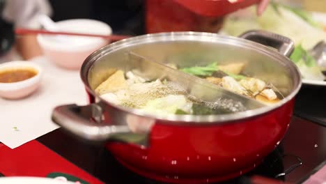 simmering hotpot with fresh ingredients in bangkok