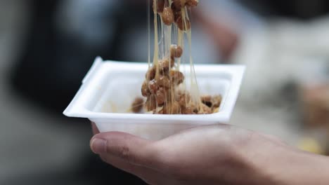 sequence of eating natto from a disposable tray