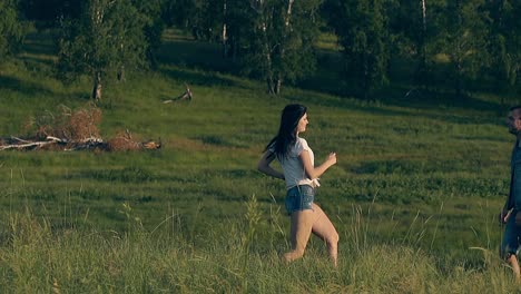 young woman runs to man in denim dressing and kisses