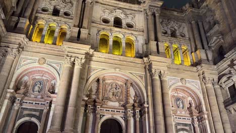 malaga catholic cathedral at night yellow lights inside historical building spain