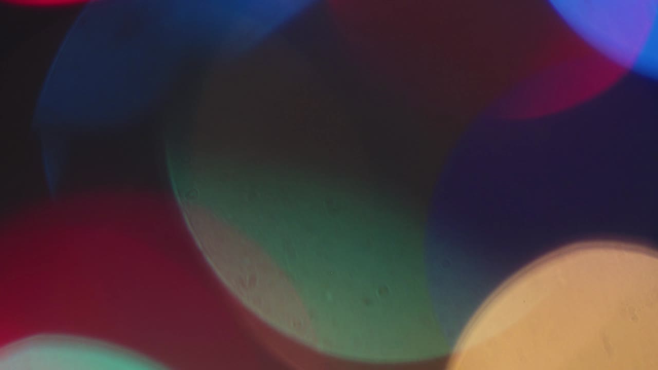 Blurry Christmas fantastic colored lights twinkle brightly.