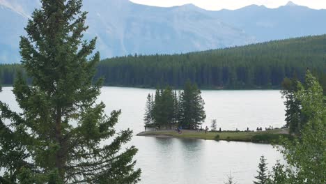 landscape beautiful natural view of two jack lake with beautiful pine tree forest and rockies mountain in background in banff national park,alberta,canada in summer sunshine daytime