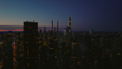 Rising-footage-of-night-city.-Illuminated-high-rise-office-or-apartment-buildings.-Manhattan,-New-York-City,-USA