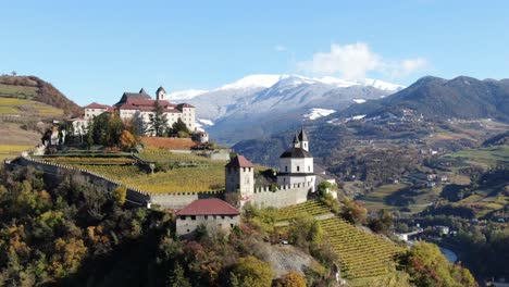 Aerial-Drone-Over-a-medieval-Castle-in-the-middle-of-the-Vineyards-in-Italy-named-Salita-Sabiona