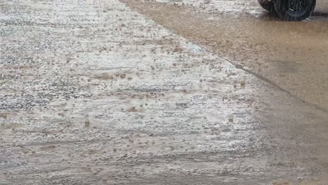 rain in the open parking lot, rain drops falling on the concrete surface