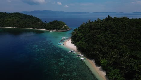 pull back drone shot of exotic island in palawan, phillippines during dusk.