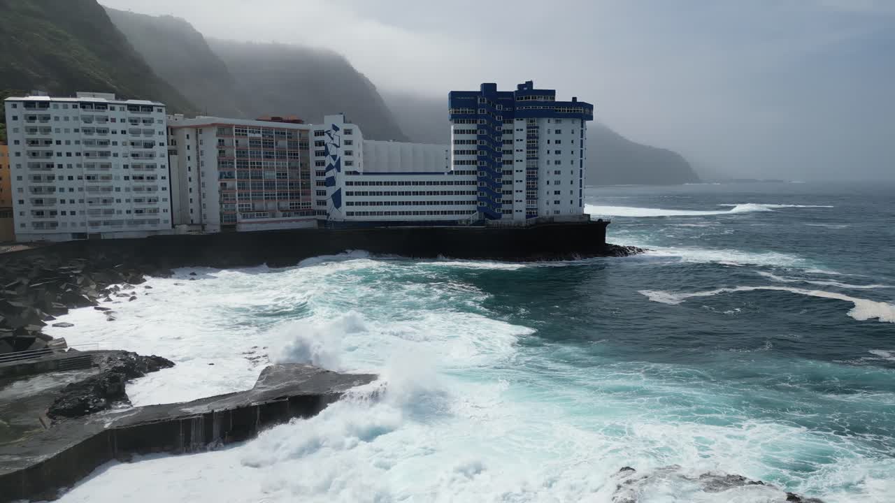 Mesa del Mar natural sea water pools with strong waves in Tenerife Canary islands Spain, Aerial dolly right shot
