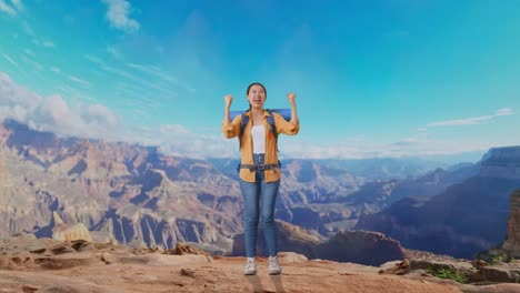 full body of asian female hiker with mountaineering backpack screaming goal celebrating the success while traveling at the top of mountain